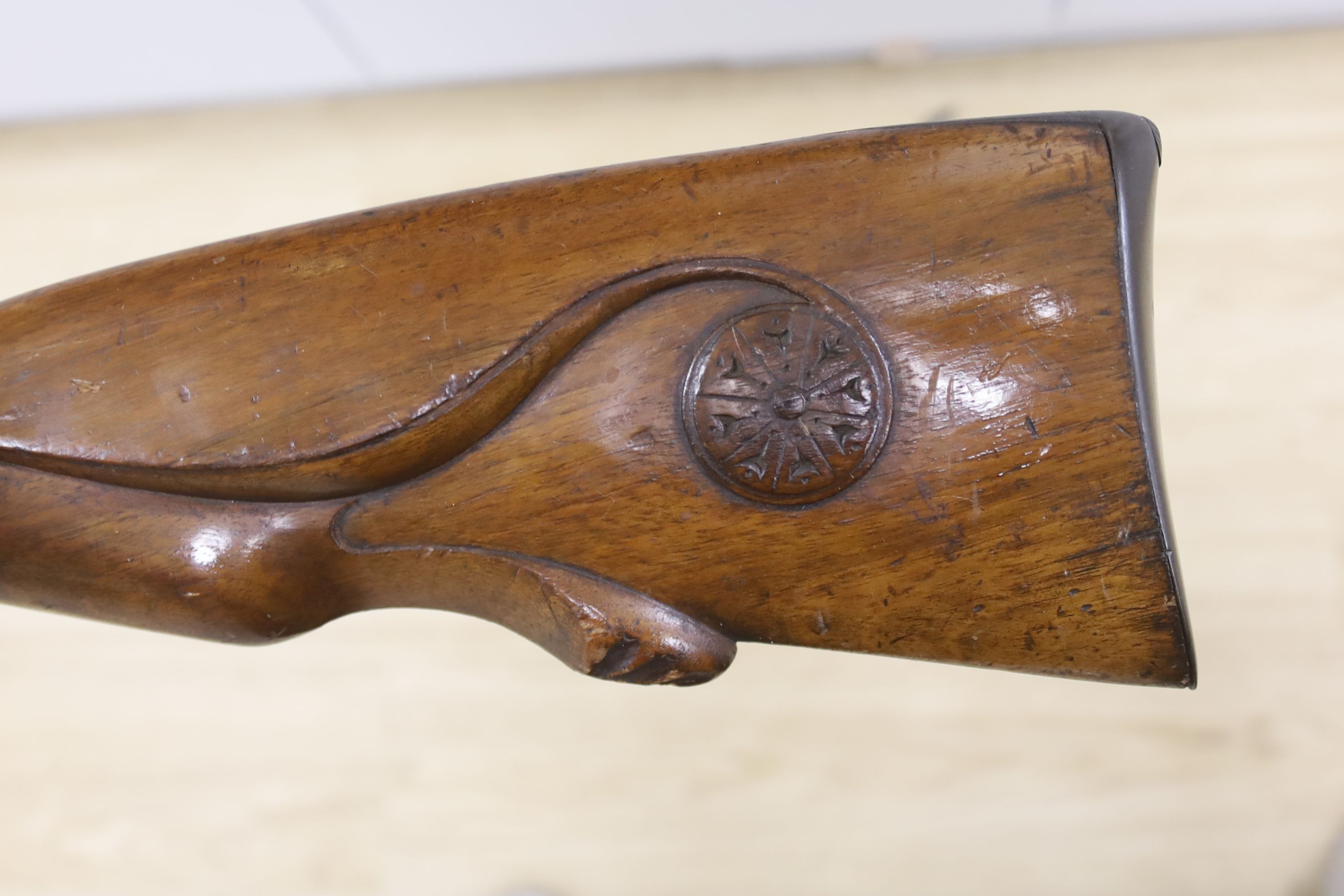 An early 19th century Belgian percussion cap carbine with carved walnut stock and silver inlaid barrel, bears indistinct mark, barrel 38cm, overall length 78cm